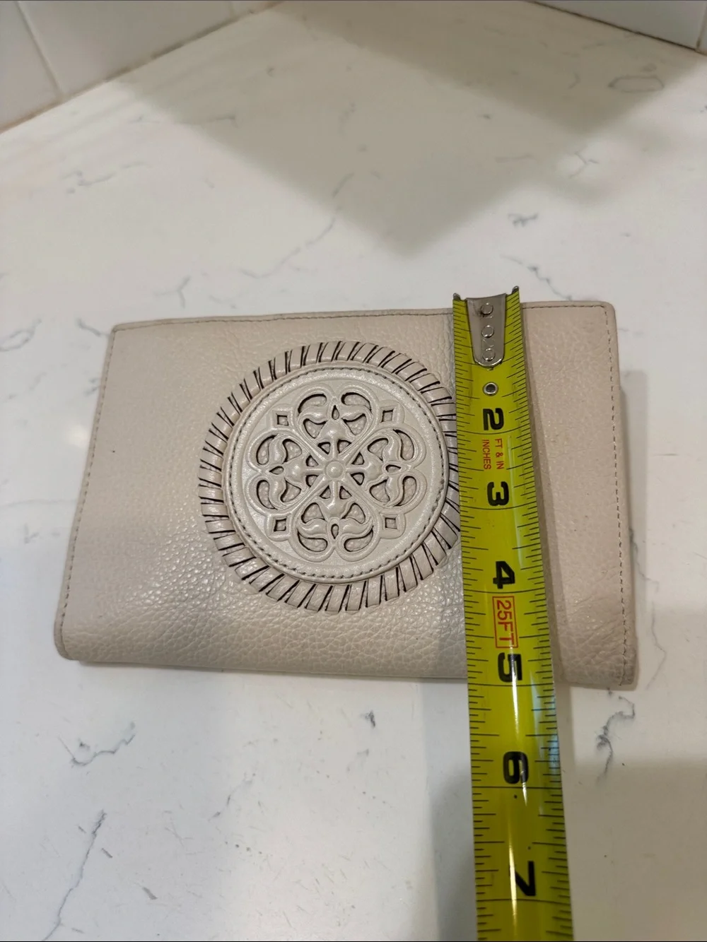 Brighton Cream Pebbled Leather Ferrara Fold Wallet with Embossed Medallion